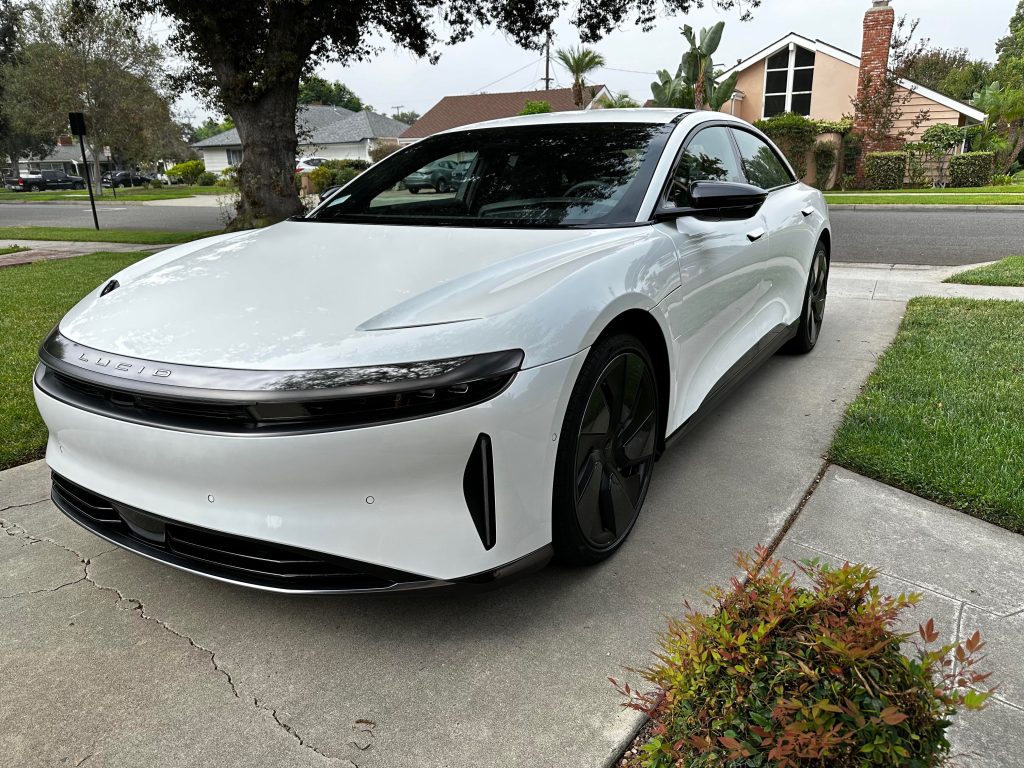White Lucid Air luxury electric vehicle prepared for enclosed auto transport
