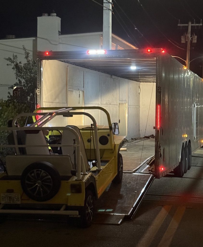 Enclosed auto transport carrier loading a Moke for Nantucket shipping