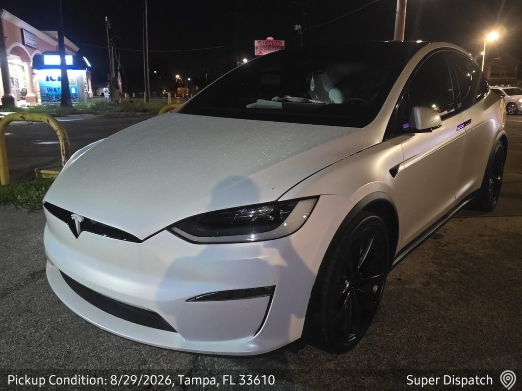 White Tesla Model X at pickup in Tampa, Florida before enclosed transport
