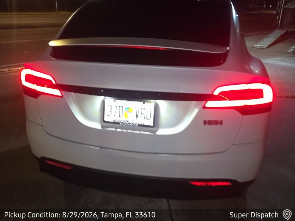 Tesla Model X at nighttime pickup in Tampa, Florida for expedited auto transport